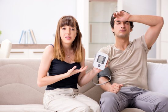 woman measures blood pressure of her partner