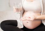 pregnant woman takes omega-3 supplement