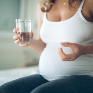 pregnant woman takes medication 